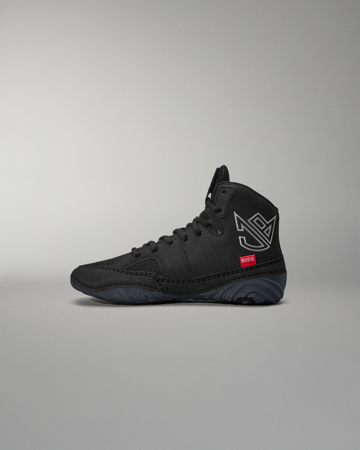 Black high-top wrestling shoe with a logo on a gray background