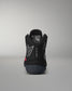 Black wrestling shoe with visible branding on a gray background