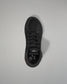 Black wrestling shoe on a light gray background
