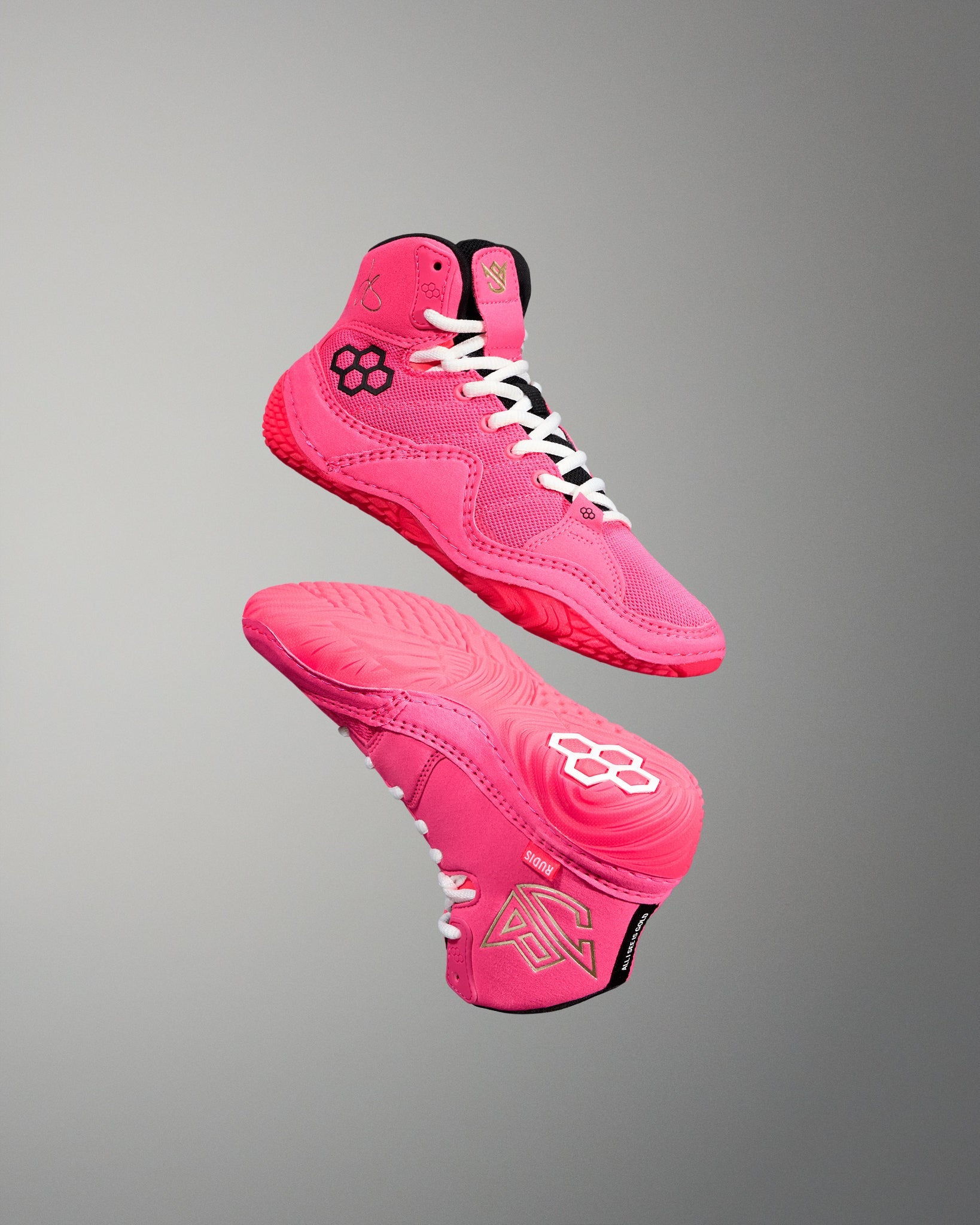 Pink high-top wrestling shoe with white laces on a gray background