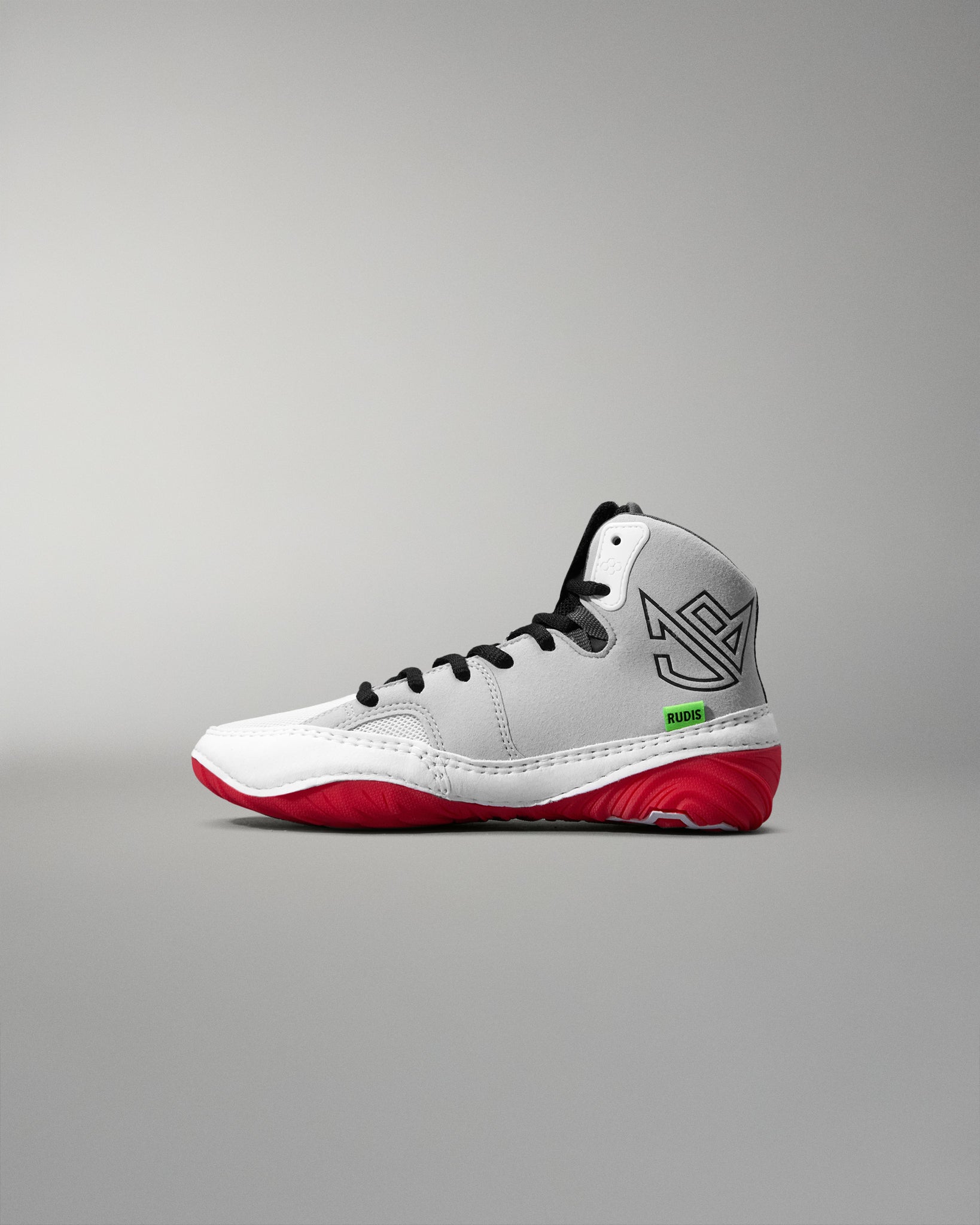 White wrestling shoe with red soles on a gray background