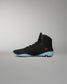 RUDIS JB1 Youth Wrestling Shoe in Dark Shark shown from the medial side, featuring the black high-top construction, tonal JB branding, red RUDIS accent, and light blue outsole.