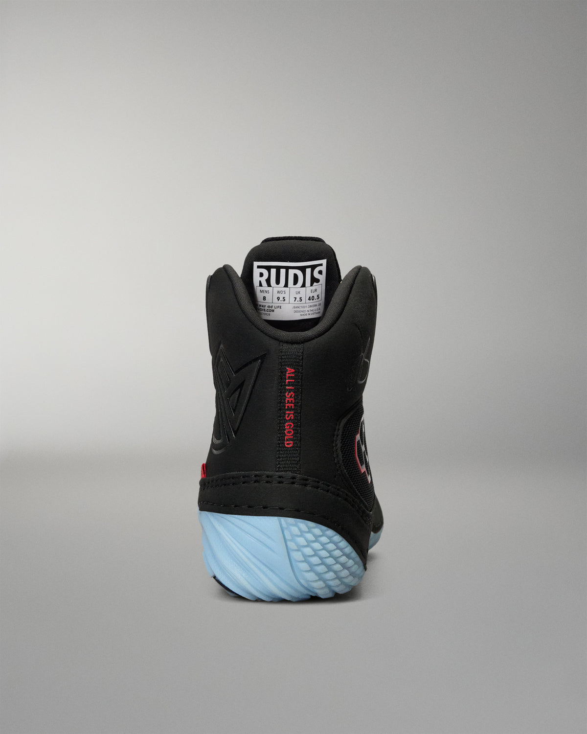 RUDIS JB1 Youth Wrestling Shoe in Dark Shark shown from the rear, featuring the padded high-top collar, tonal JB branding, red All I See Is Gold detail, and light blue heel outsole.