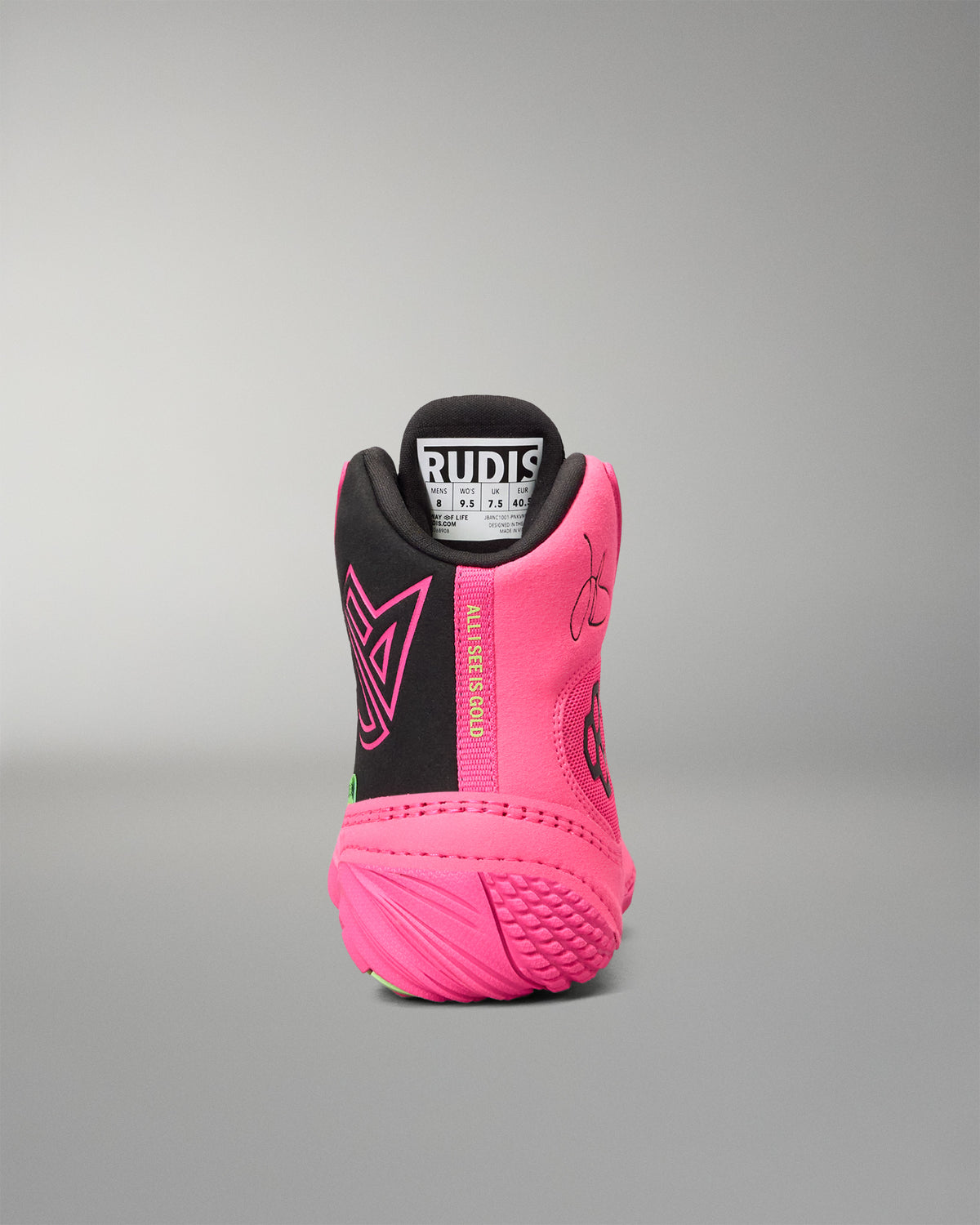 A high-top wrestling shoe shown from the rear, featuring a vibrant pink and black color scheme with a white and black Rudis logo on the tongue.
