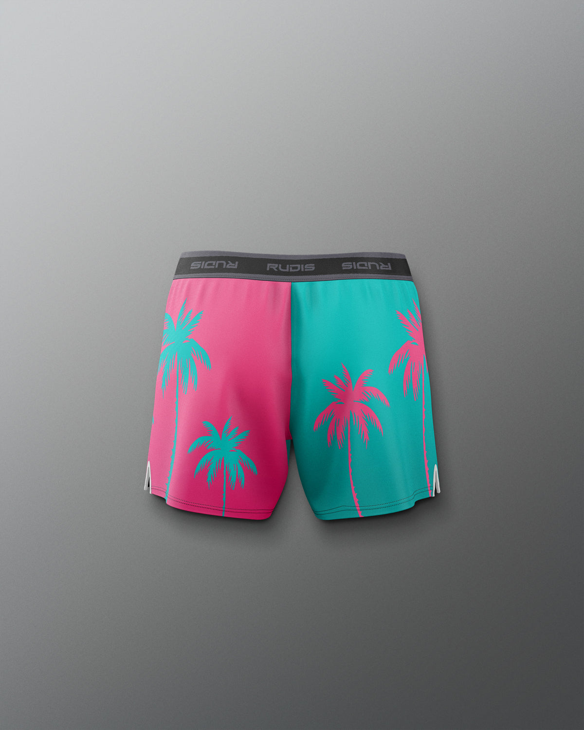 Pink and teal shorts with palm tree design on a gray background