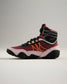 A stylish high-top athletic shoe featuring a bold red and black design with unique yellow and orange accents ideal for sports and casual wear