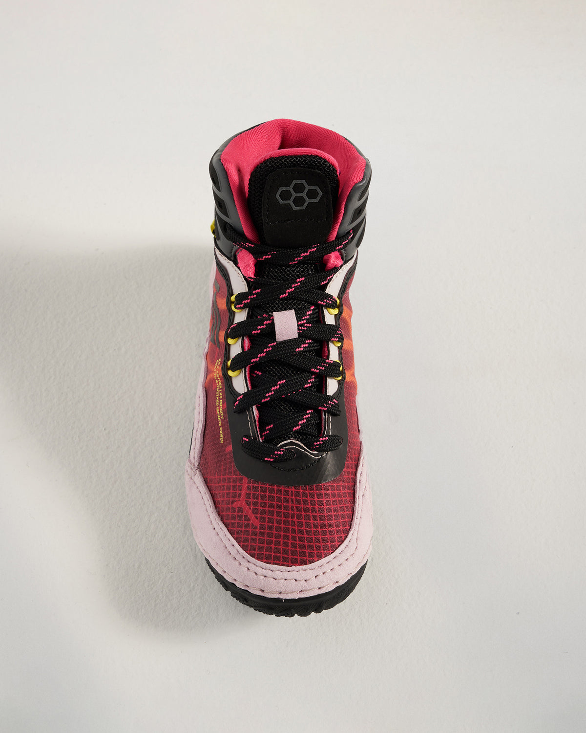 A modern athletic shoe featuring a vibrant red and pink design with a high-top structure breathable mesh upper and durable rubber sole