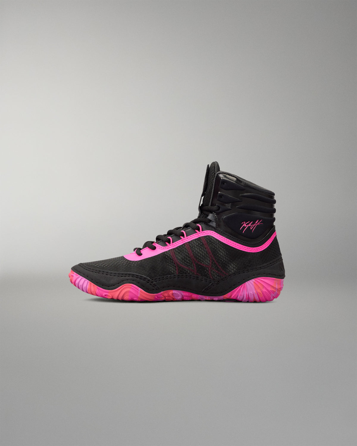 A high-top athletic wrestling shoe in black with vibrant neon pink accents on the laces, collar trim, and sole, shown in profile against a neutral gray background.