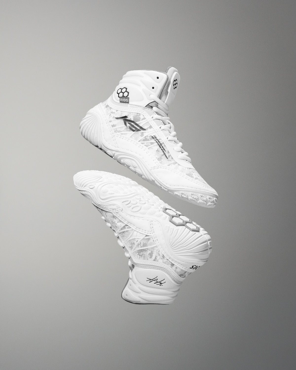 White high-top sneakers with RUDIS brand logo and Kyle Snyder KS logo on a gray background