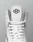 White wrestling shoe with a brand logo on a gray background
