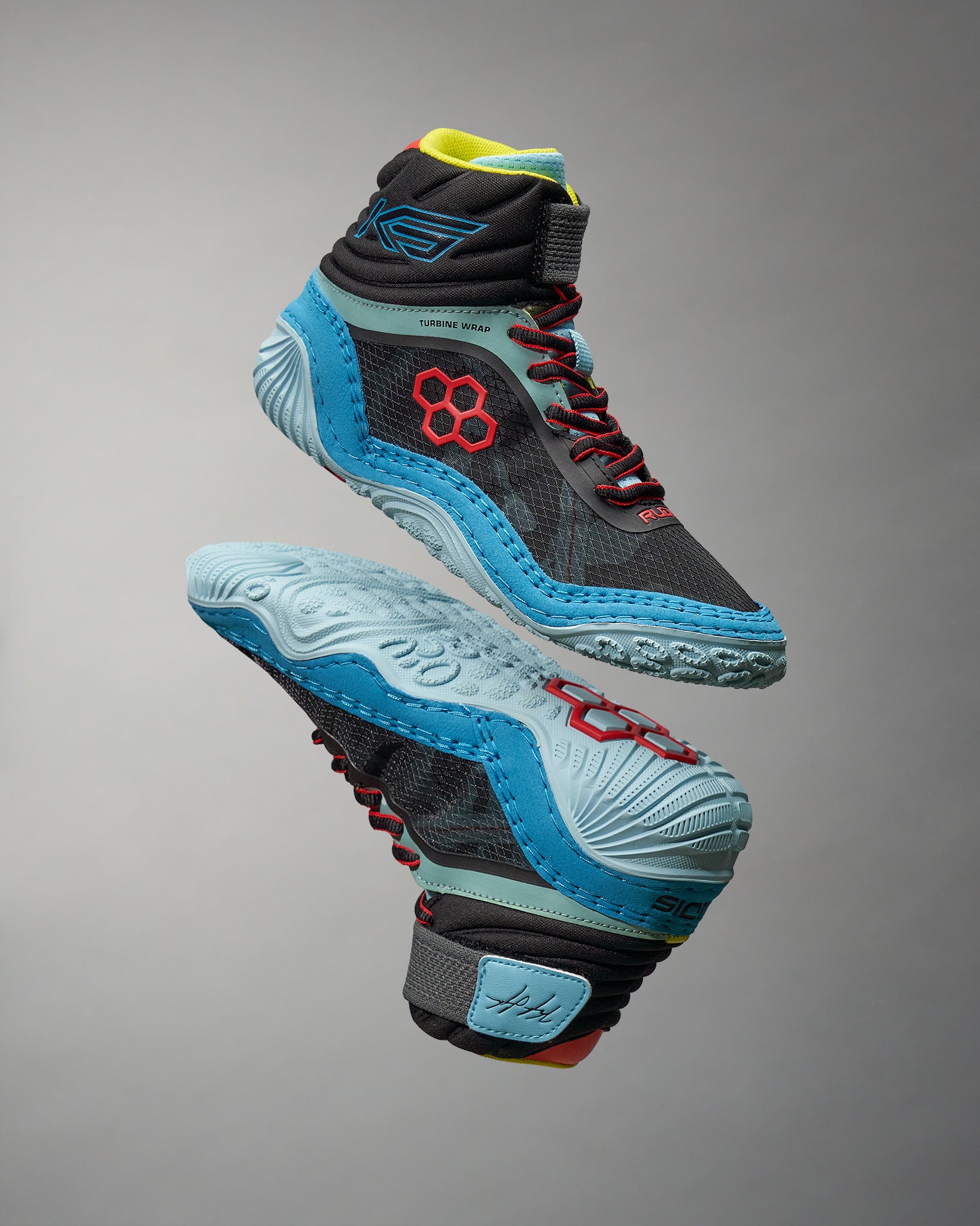 A modern pair of high-top athletic shoes featuring a black upper with vibrant blue red and yellow accents designed for performance in sports