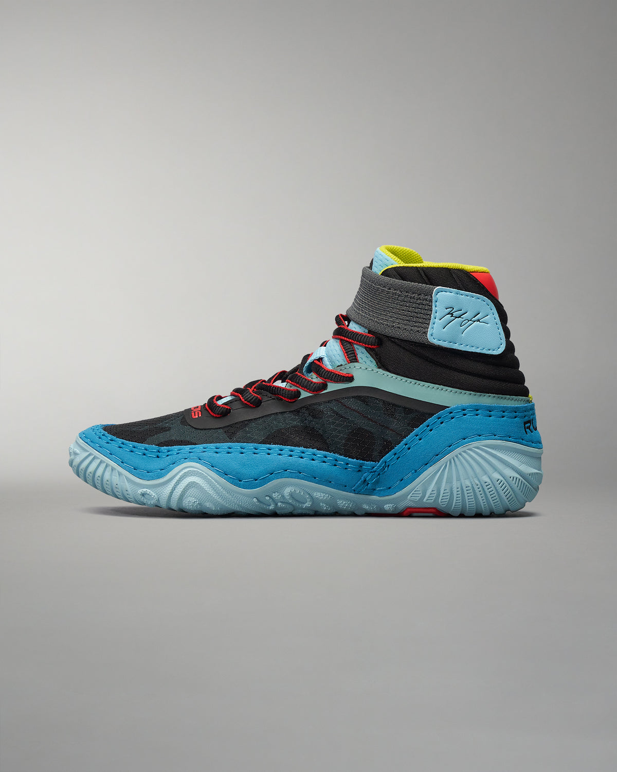This image showcases a modern high-top athletic shoe featuring a sleek black design with blue accents and intricate lacing ideal for sports or casual wear