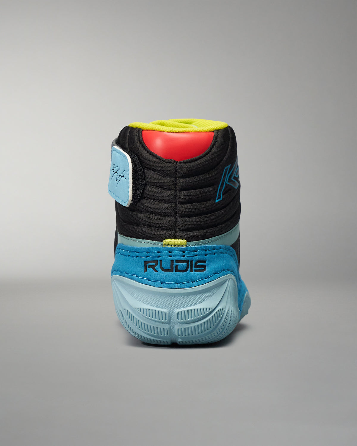 A rear view of a sleek black and blue athletic shoe featuring a textured sole and vibrant accent colors