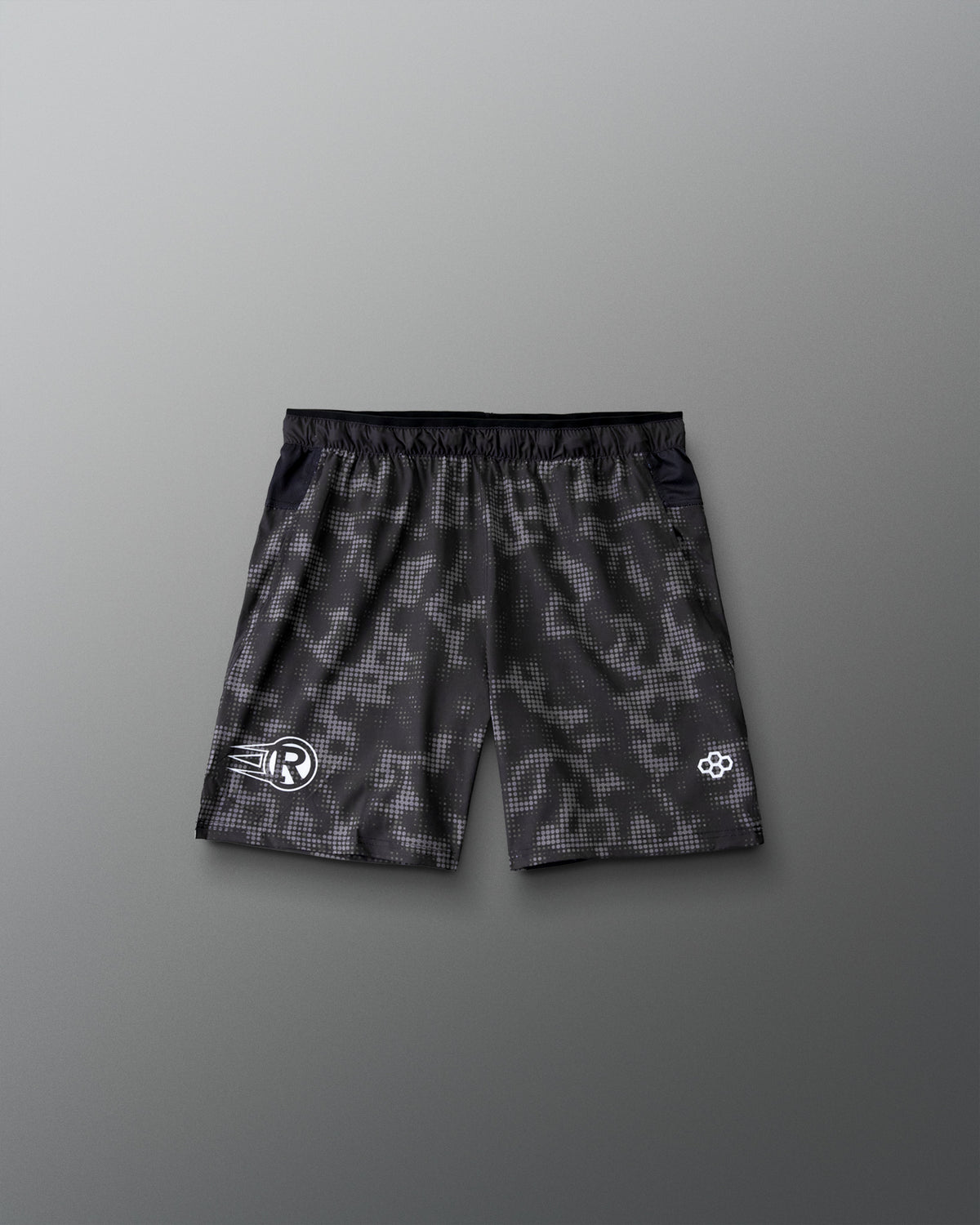 RUDIS Resolute Attack youth lacrosse shorts in black with a tonal camo print, featuring an elastic waistband, athletic fit, and clean back design.