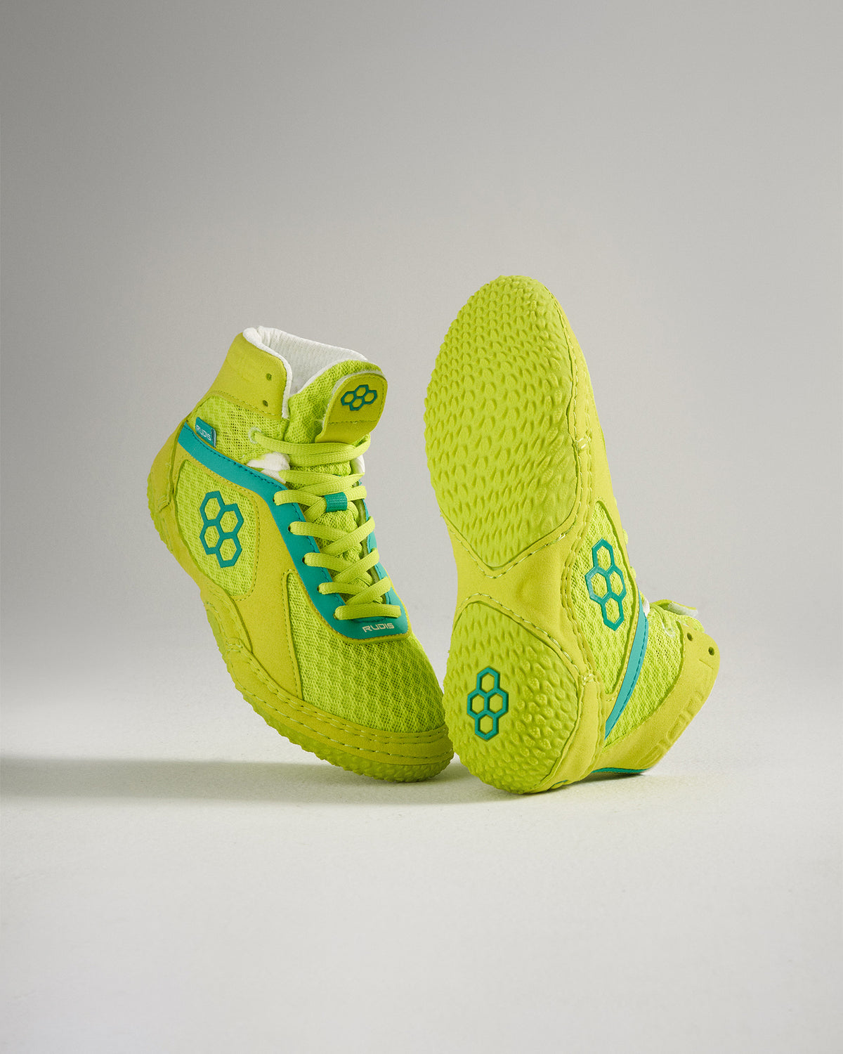 A vibrant pair of high-top athletic shoes in neon yellow with blue accents designed for maximum performance and style