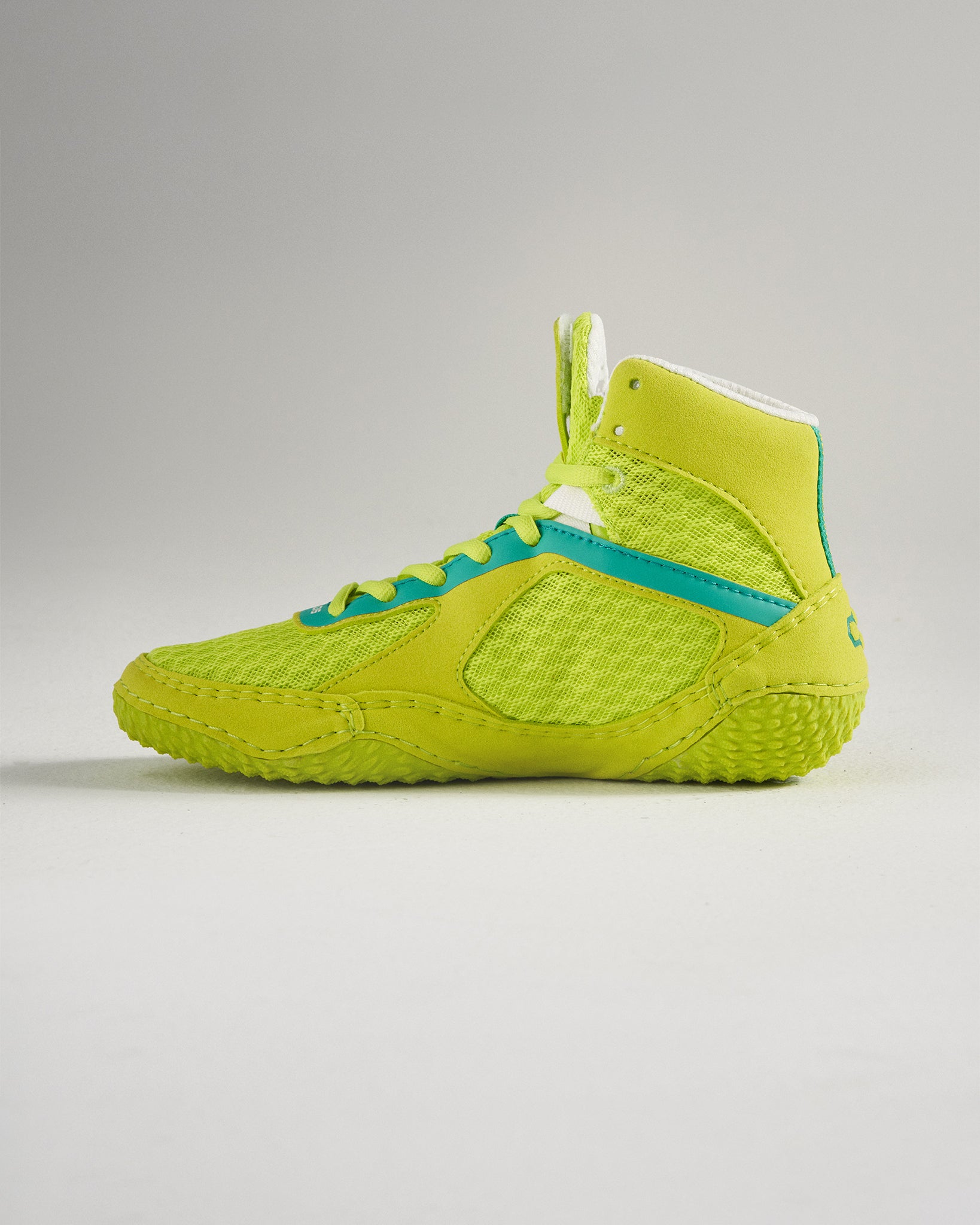 A vibrant green athletic shoe featuring a high-top design mesh upper and textured grip sole ideal for various sports activities