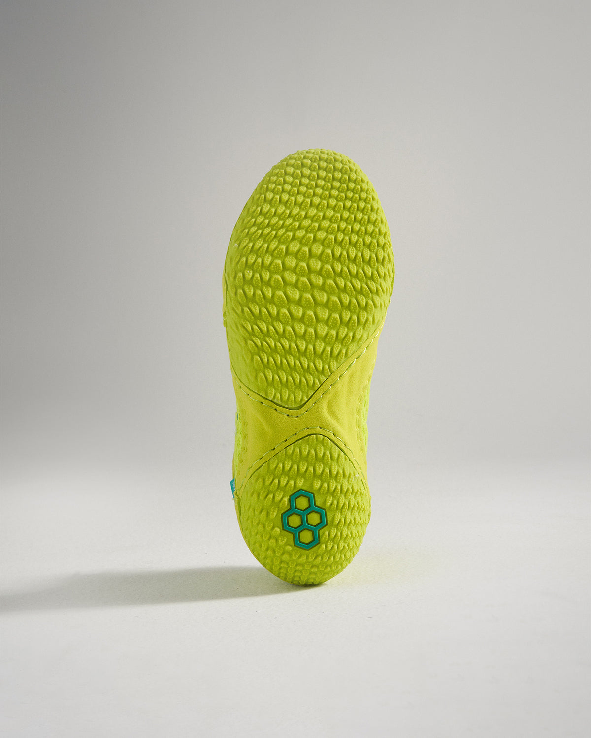 A vibrant green shoe sole featuring a textured surface and a modern design for enhanced grip