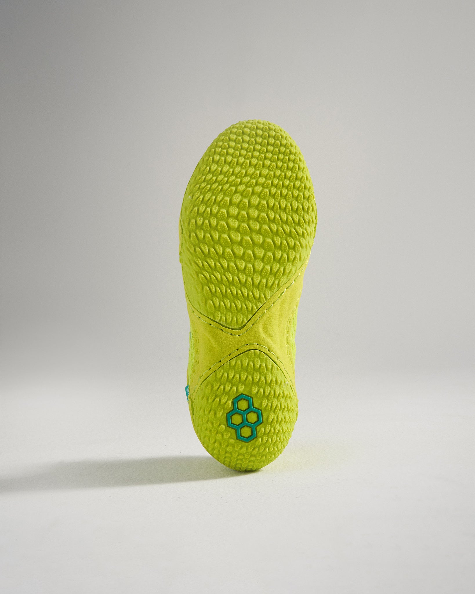 A vibrant green shoe sole featuring a textured surface and a modern design for enhanced grip