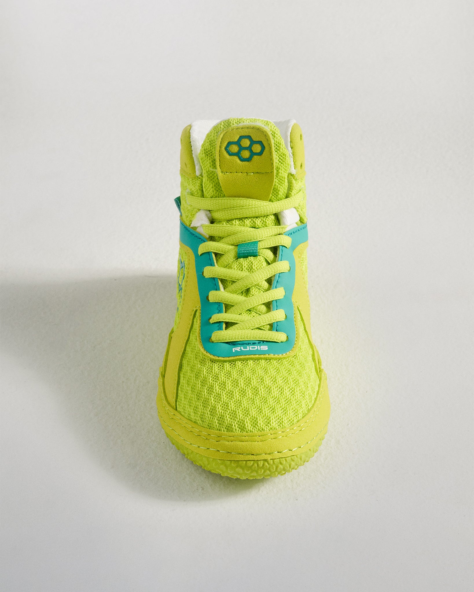 This image showcases a vibrant pair of green and blue athletic shoes with a textured sole designed for comfort and performance