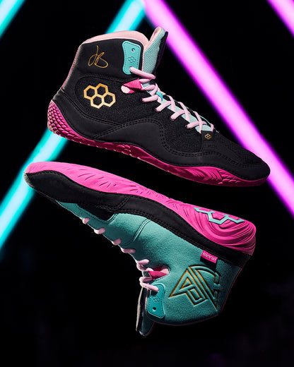 Black, pink, and teal high-top sneakers with a reflective surface on a dark background.