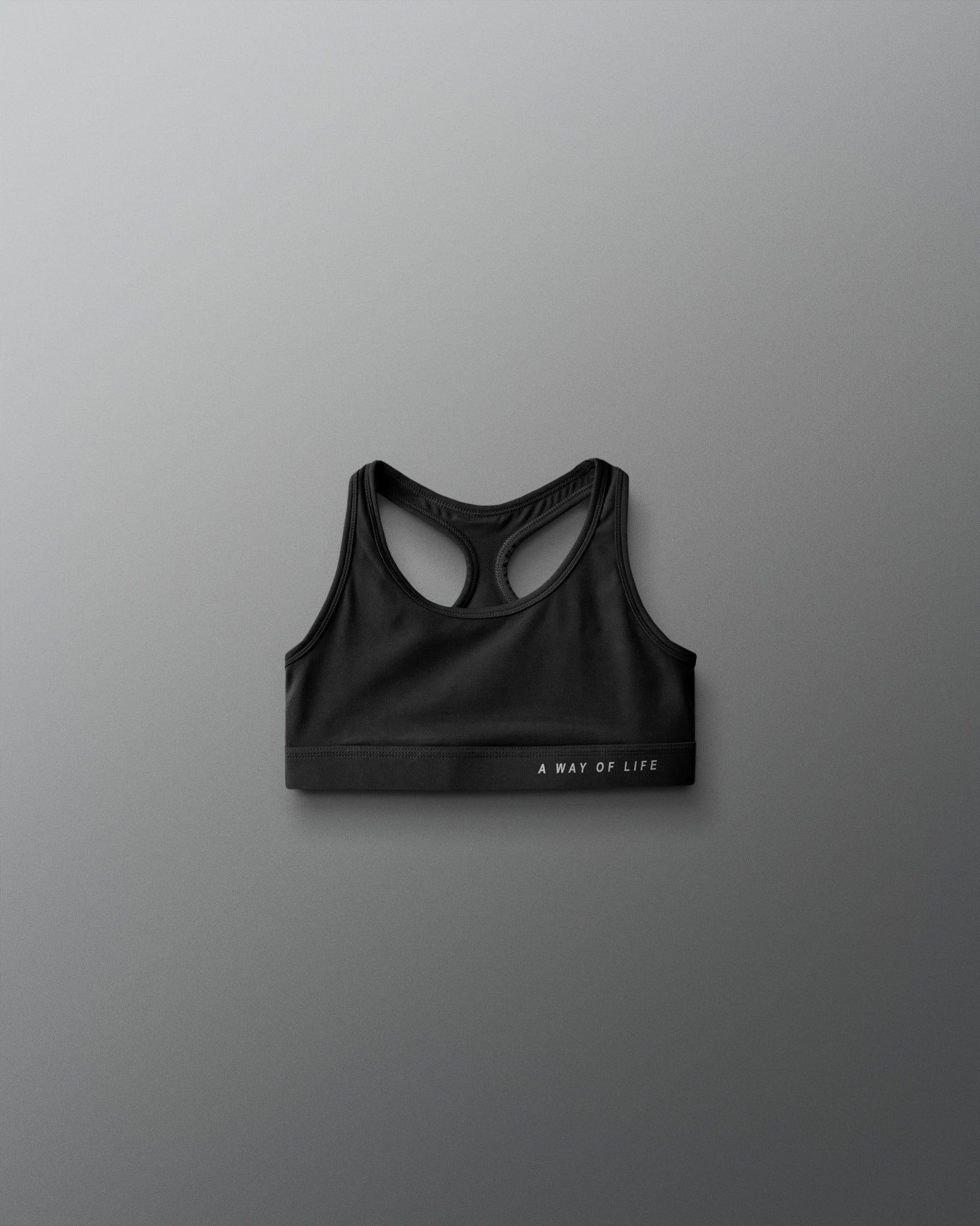Black sports bra on a gray background