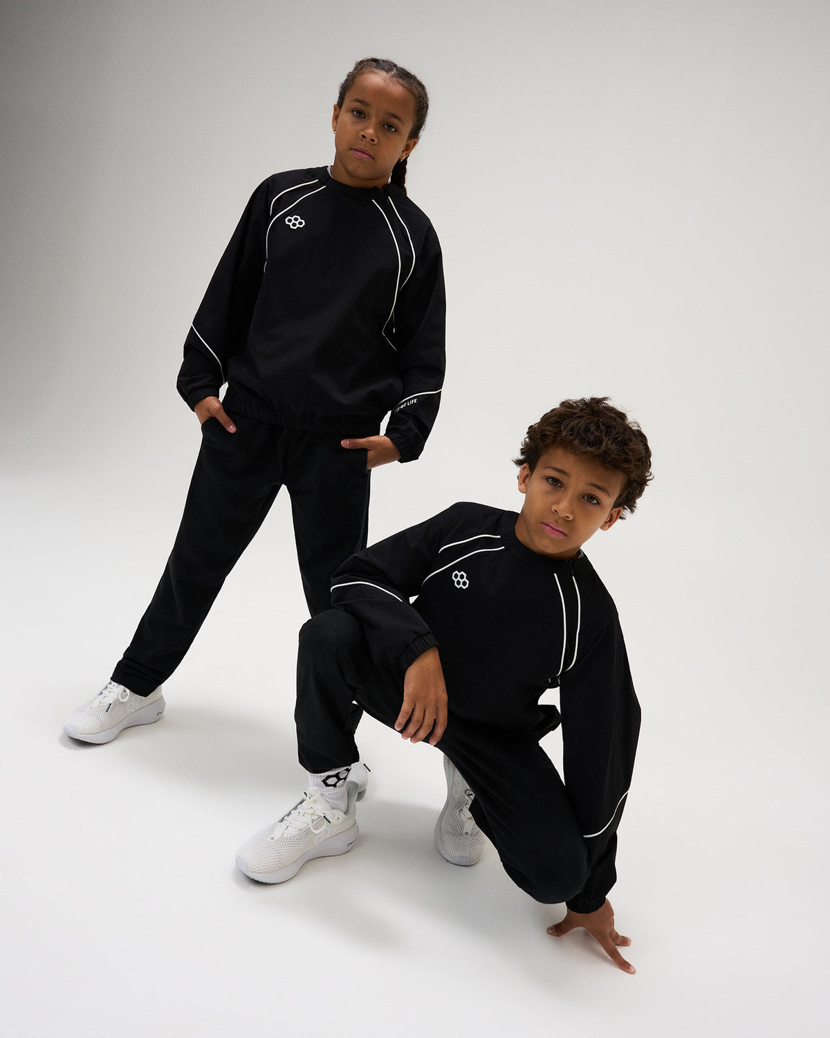 RUDIS Youth Movement Crewneck in Black, featuring contrast white piping, RUDIS chest branding, and an athletic silhouette built for movement.