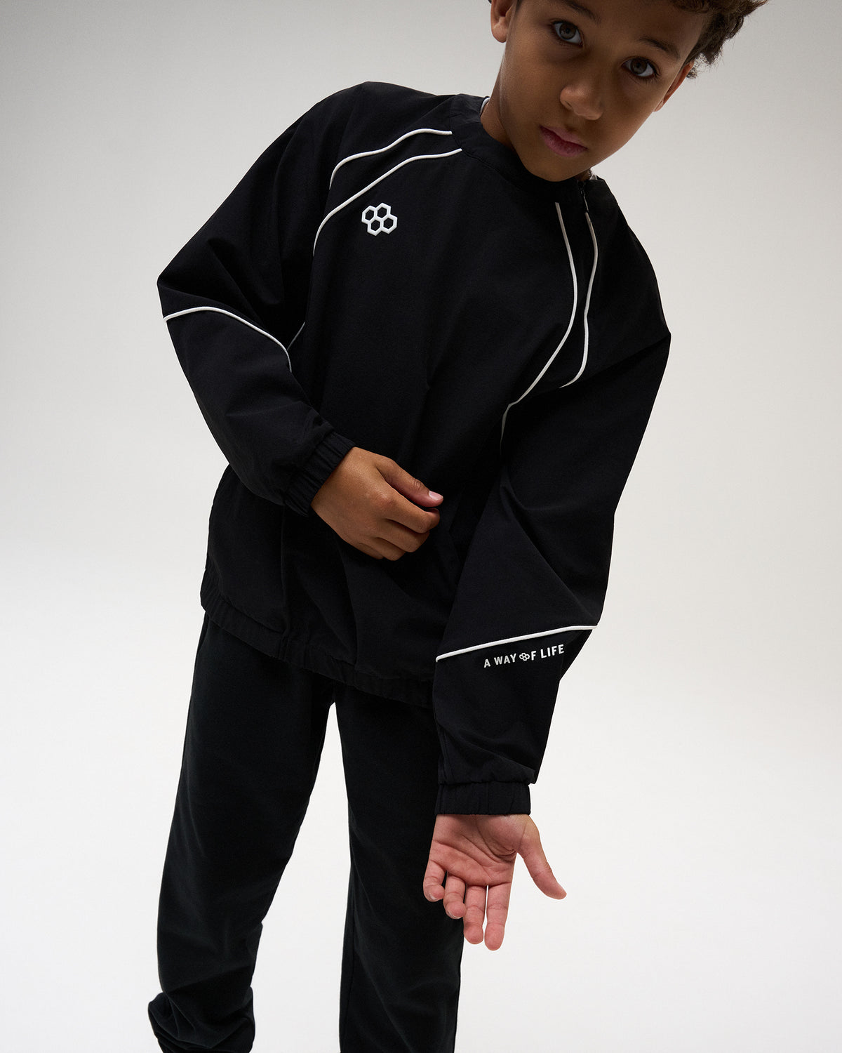 RUDIS Youth Movement Crewneck in Black, highlighting contrast white piping, RUDIS chest branding, elastic cuffs, and “A WAY OF LIFE” sleeve detailing.