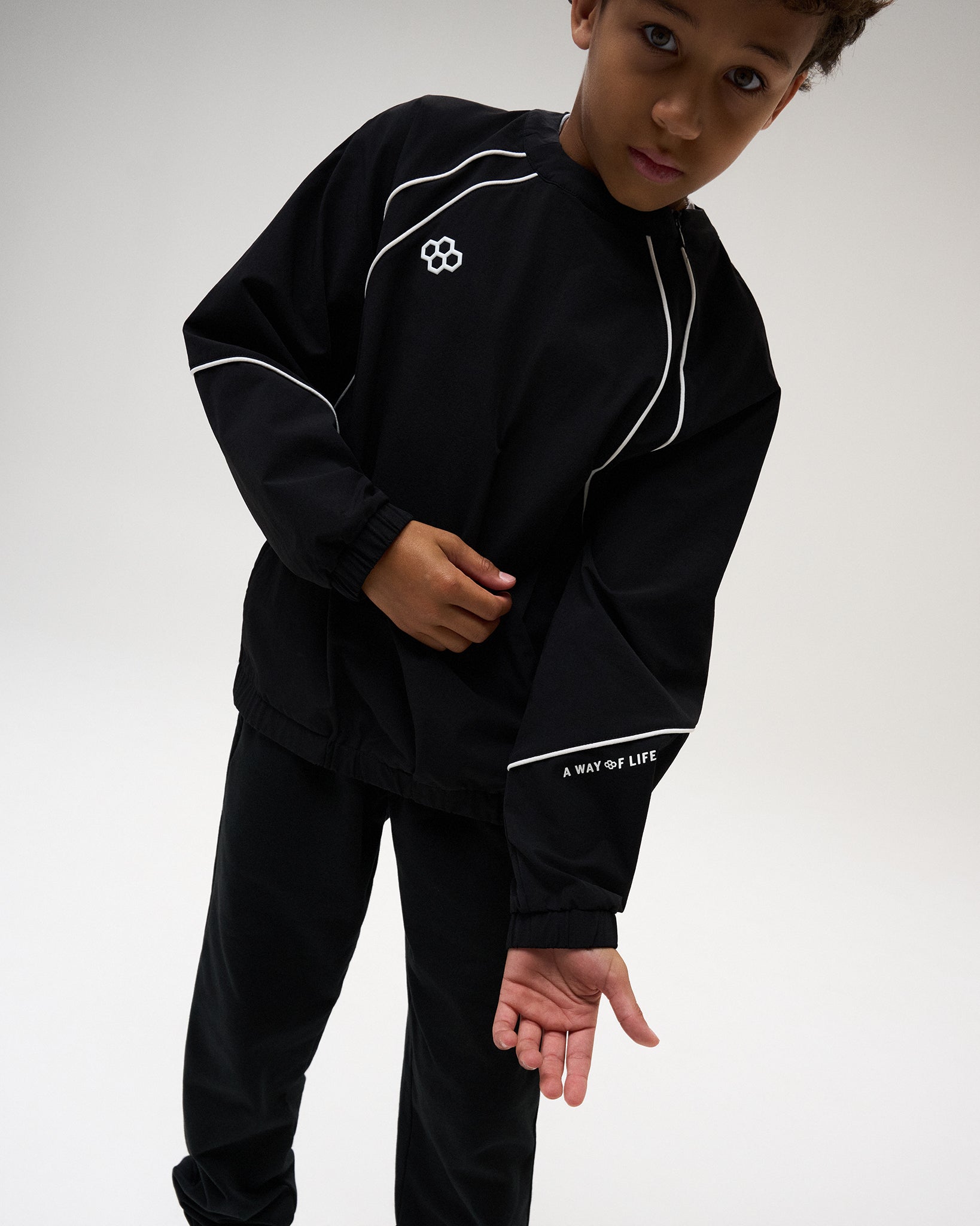 RUDIS Youth Movement Crewneck in Black, highlighting contrast white piping, RUDIS chest branding, elastic cuffs, and “A WAY OF LIFE” sleeve detailing.