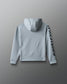 Gray hoodie with a brand logo on the sleeve against a gray background