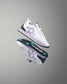 White sneakers with purple accents and black soles on a gray background