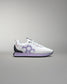 White and purple sneaker on a gray background