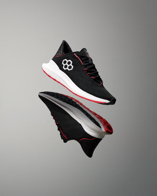 Black and red athletic shoe on a gray background
