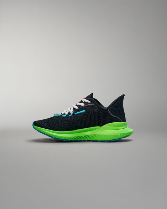Black and green running shoe on a gray background