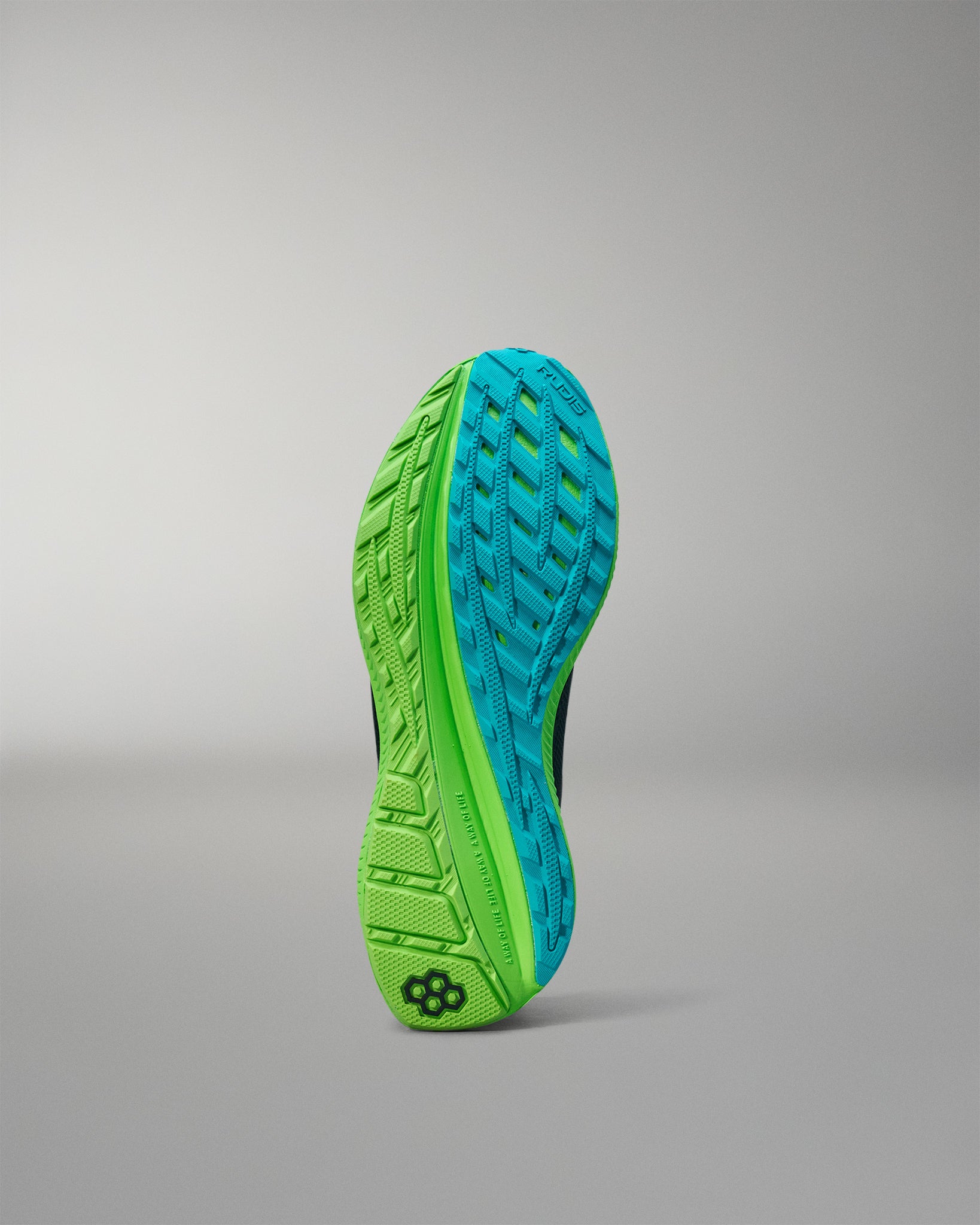 Green and blue athletic shoe sole on a gray background