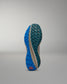 Blue and green sole of a shoe on a gray background