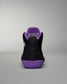 Black and purple sneaker with visible brand logo on a gray background
