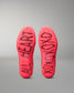 Red wrestling shoes with black branding on a gray background