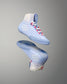Light blue wrestling shoes with white and pink accents on a gray background