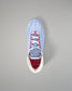 Light blue wrestling shoe with colorful sole on a gray background