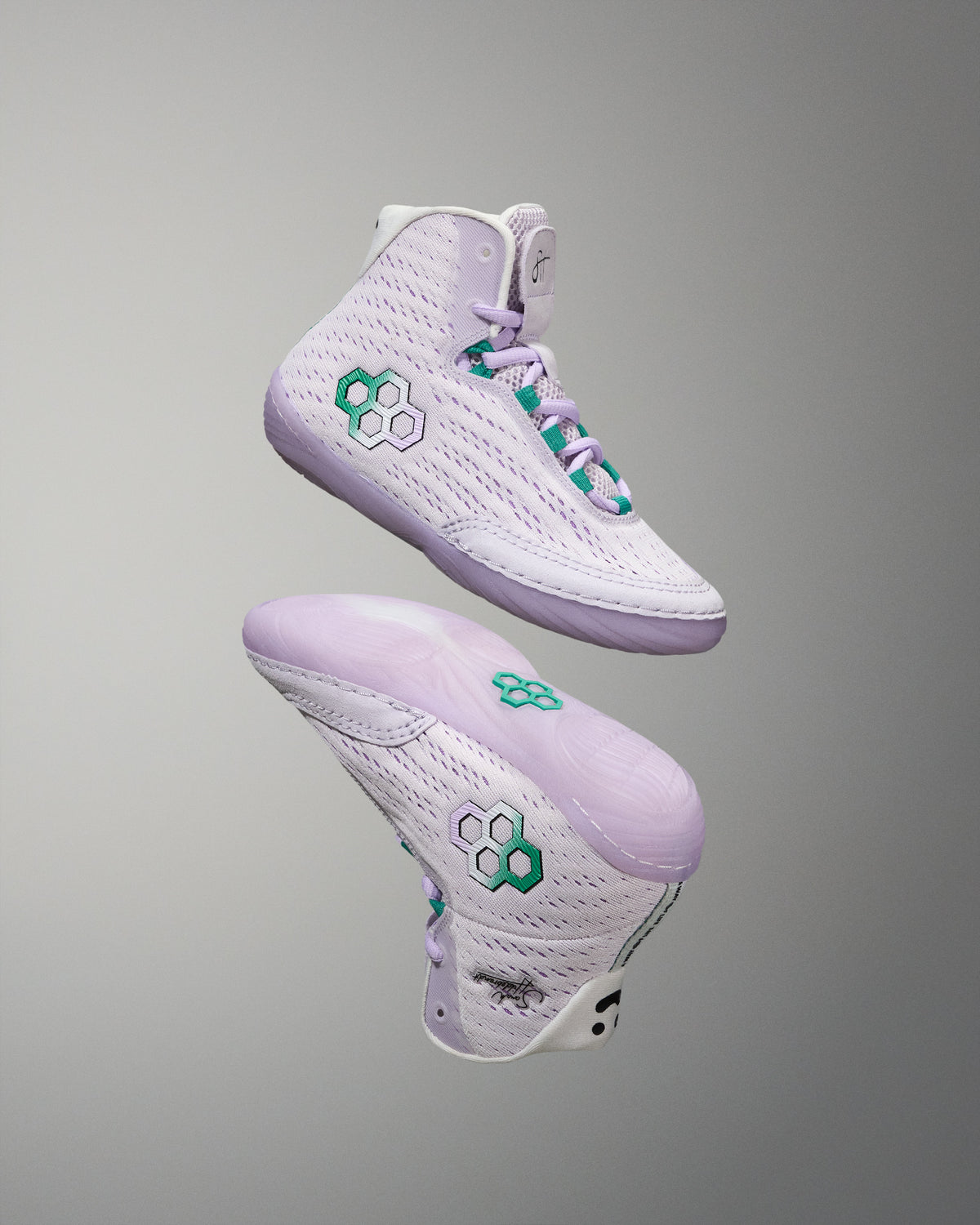 White sneakers with green accents on a gray background