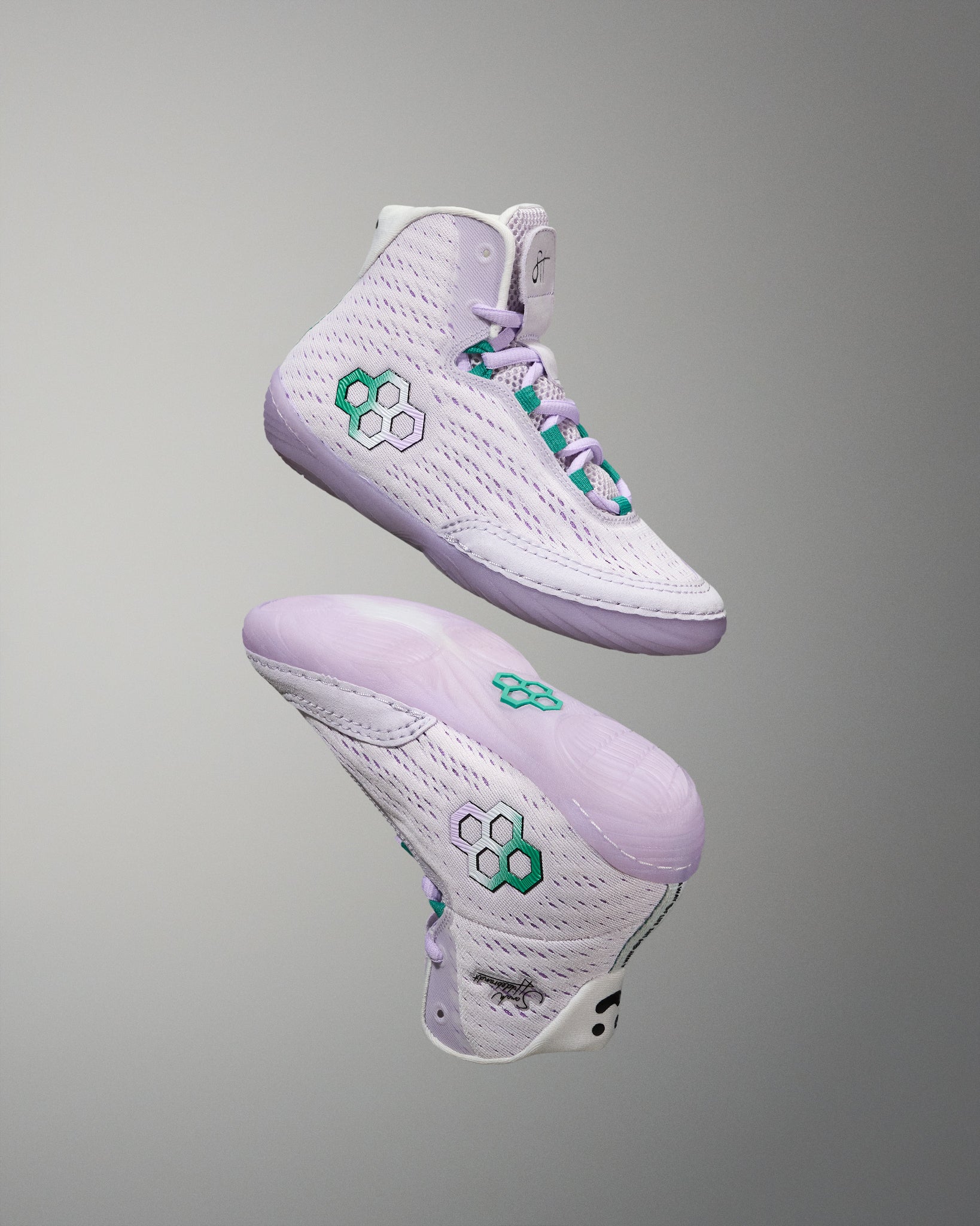 White sneakers with green accents on a gray background