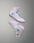 White sneakers with green accents on a gray background