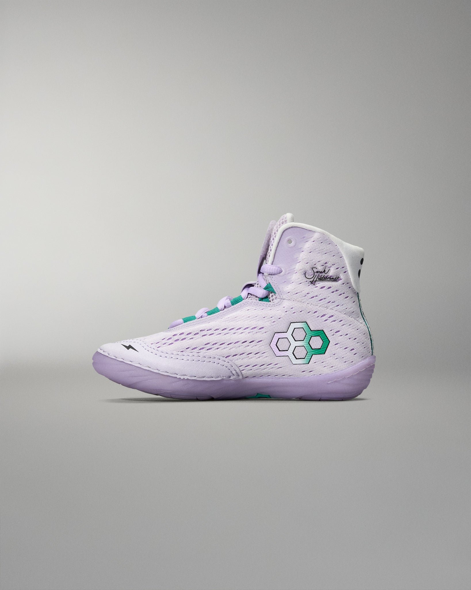 White high-top sneaker with green accents on a gray background