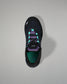 Black sneaker with purple accents on a gray background