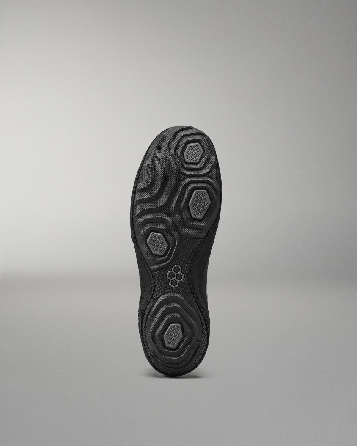 Black Wrestling Shoes sole with textured pattern on a gray background
