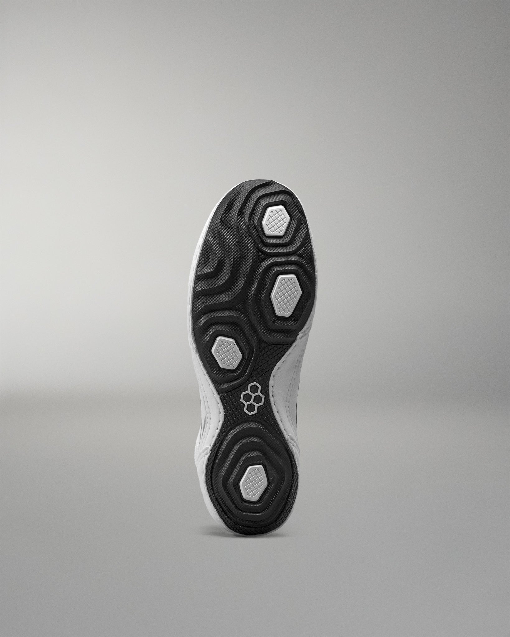 Close-up of a Wrestling Shoe sole with a brand logo on a gray background