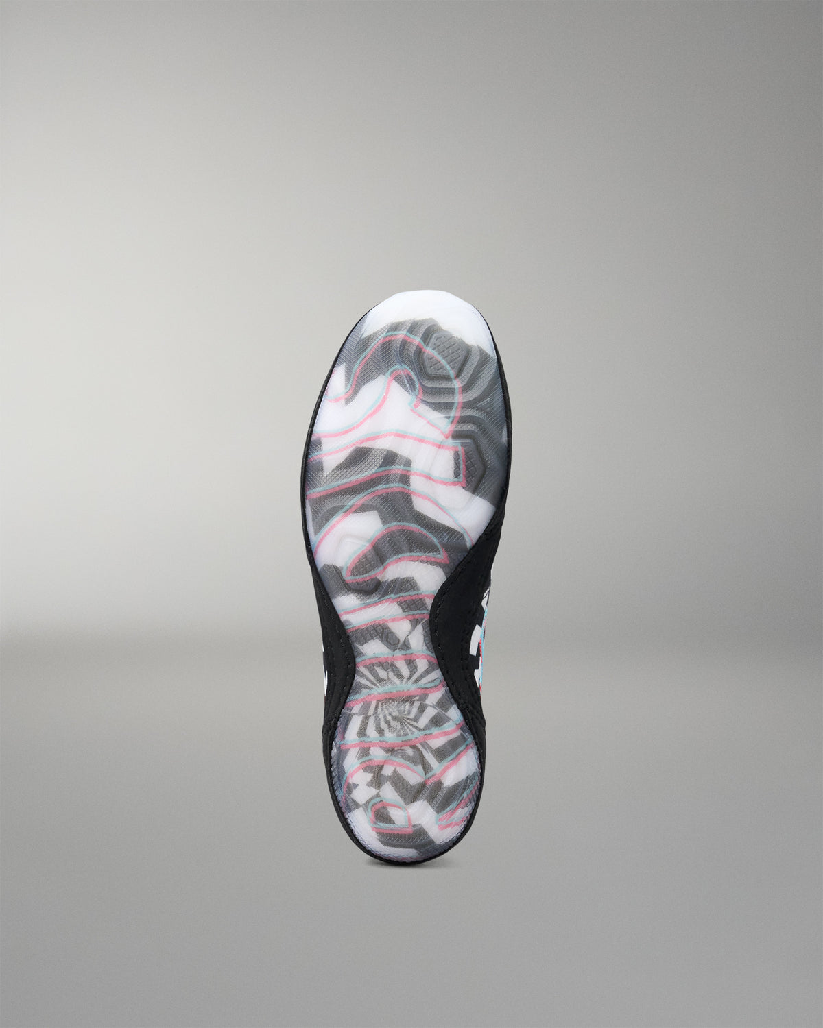 A single wrestling shoe shown from the sole view, featuring a black outsole with a white, gray, and pink abstract wavy pattern, set against a neutral gray background.