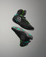 Black wrestling shoes with green accents on a gray background