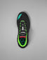 Black wrestling shoe with green accents on a gray background