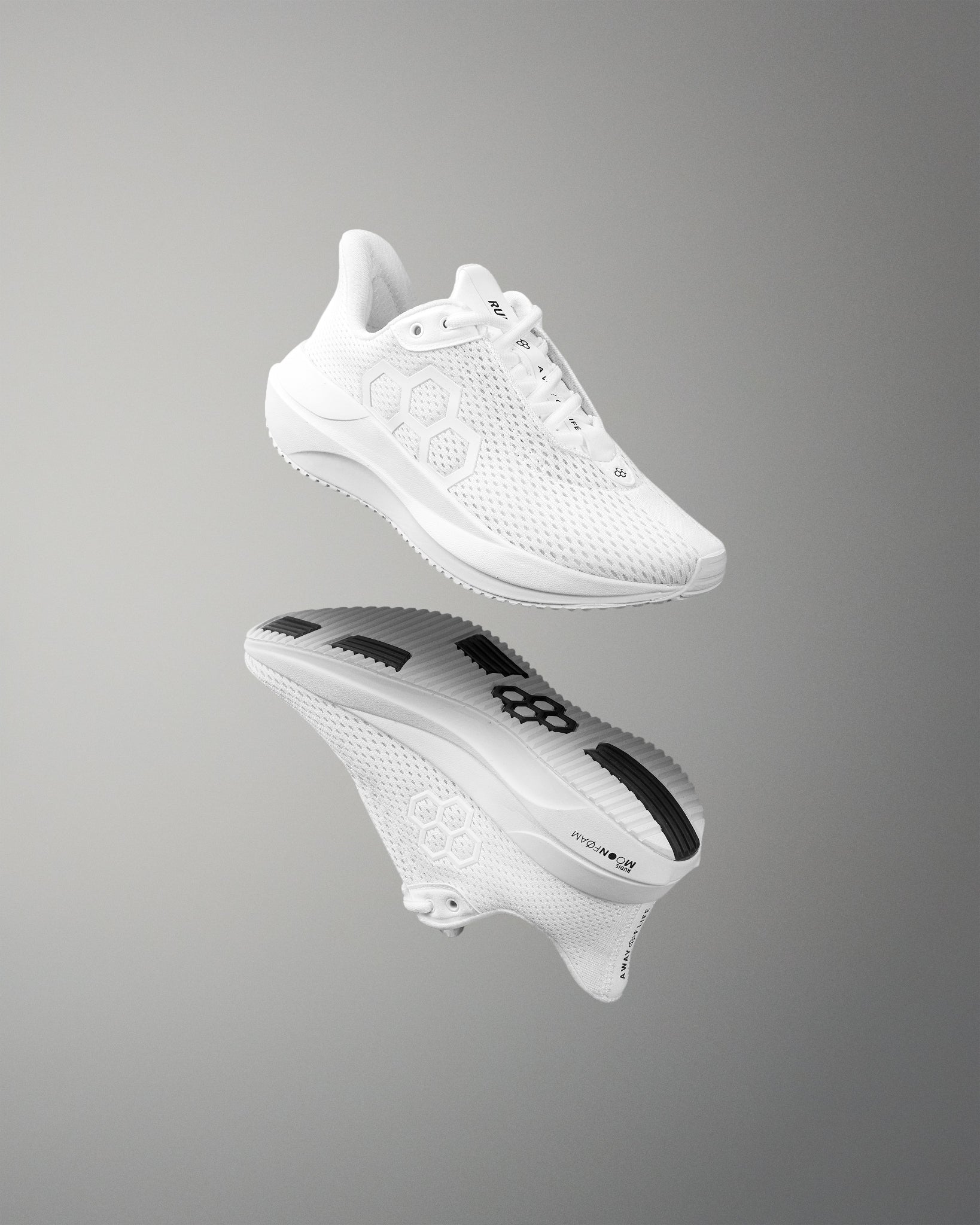 White athletic shoe with brand logo on a reflective gray surface